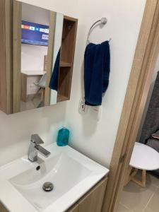 a bathroom with a sink and a mirror at Marina Club Piso 8 in Cartagena de Indias +33 photos