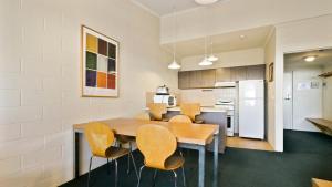 a kitchen with a dining room table and chairs at Alpine Heights 04 in Mount Hotham