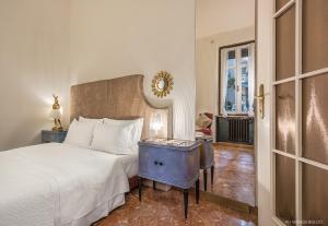 a bedroom with a bed and a table with a night stand at Billie's Flat RED - art & design apt in Verona historic centre in Verona