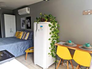 a room with a white refrigerator with plants on it at Tiny House Paraiso Minicasas Com Hidromassagem in Pouso Alegre