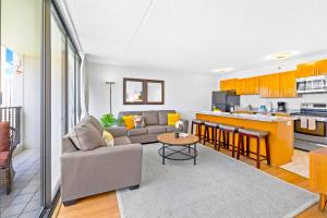 a living room with a couch and a kitchen at 1BR with Stunning Ocean Views, Near Beach & Parking in Honolulu