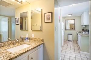 a bathroom with two sinks and a mirror at Oceanfront Condo & Walking Distance to Beach and Town- Hale Kona Kai 207 by Casago Kona in Kailua-Kona +15 photos