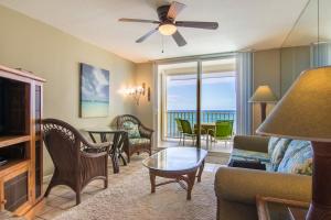 a living room with a couch and a table and chairs at Oceanfront Condo & Walking Distance to Beach and Town- Hale Kona Kai 207 by Casago Kona in Kailua-Kona