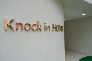 a sign that reads knock in korea on a wall at Knock In Hotel Daejeon by ANNK in Daejeon