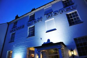 a white building with the words wisdom hotel on it at The White Lion Hotel in Aldeburgh