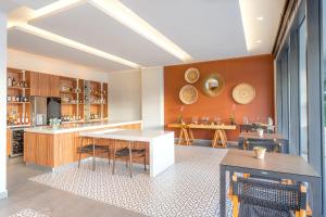 a kitchen with wooden cabinets and a white counter top at Breathless Cabo San Lucas - Adults Only in Cabo San Lucas