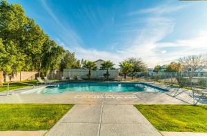 a swimming pool in a yard with a fence at Coolidge 3bd 2ba upgraded apartment with amenities in Coolidge