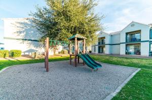 a playground with a slide in a yard at Coolidge 3bd 2ba upgraded apartment with amenities in Coolidge