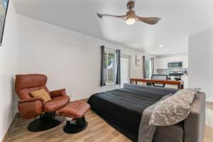 a bedroom with a bed and a chair at Coolidge 3bd 2ba upgraded apartment with amenities in Coolidge