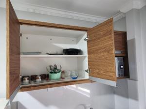 a cupboard in a kitchen with some utensils at WM Araras Apart Caldas Novas in Caldas Novas