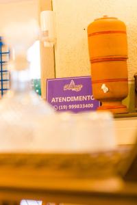 a table with a sign on it in a store at Stallage Hotel in São Pedro