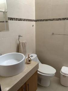 a bathroom with a sink and a toilet at Casa M in Bucerías +8 photos