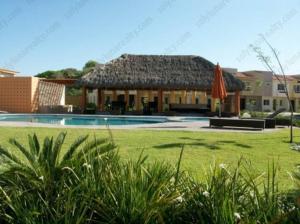 a villa with a swimming pool and a house at Casa M in Bucerías