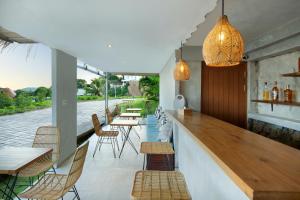 een bar met stoelen en tafels op een patio bij Telescope Villas Lombok in Kuta Lombok