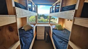 two bunk beds in a tiny house with a window at Spectacular Moana Views in Riverton