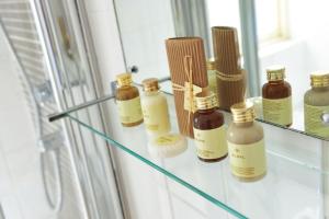 a shelf with bottles of essential oils on it at The White Lion Hotel in Aldeburgh