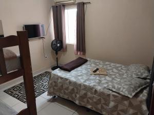 a small bedroom with a bed and a window at Parque Jockey Campos in Campos dos Goytacazes