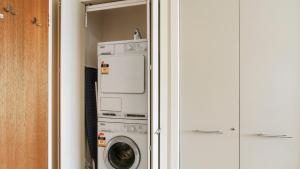 a laundry room with a washer and dryer at Chalet Hotham 13 in Mount Hotham
