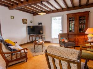 Maison confortable, charmante, jardin clos, proximité sites historiques - FR-1-616-177 في Saint-Front-la-Rivière: غرفة معيشة مليئة بالأثاث وتلفزيون بشاشة مسطحة