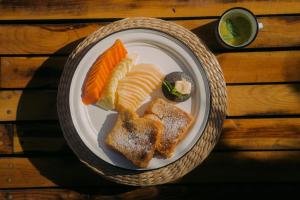 a plate of food with bread and vegetables on a table at Baja Nomads Hotel - Adults 15 Plus in Todos Santos