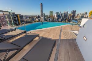 a swimming pool on the roof of a building at Multi Million River View 3BD Penthouse at SouthBank in Brisbane