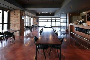 a dining room with tables and chairs and a bar at Residence Hotel K Okpo in Geoje 