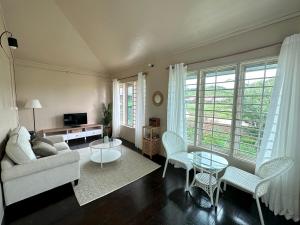 a living room with a couch and a table and chairs at Zara Lodge in Bario