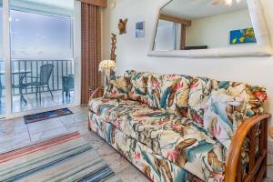 a living room with a couch and a view of the ocean at Beautifully Renovated Oceanfront Condo w/ breathe taking Views! - Hale Kona Kai 302 in Kailua-Kona