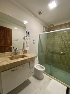a bathroom with a sink and a shower and a toilet at Pousada Mineira SJB in São João da Barra