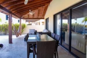 uma sala de jantar exterior com mesa e cadeiras em luxurious house with private pool in tierra del sol Resort&Golf em Palm-Eagle Beach