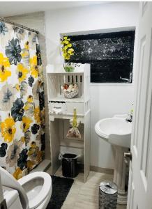 a bathroom with a white toilet and a sink at Home Sweet Home in Miami