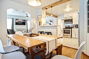 a kitchen and dining room with a wooden table and chairs at Chic 3br Haven Fully Furnished & Private Carpot in Oklahoma City