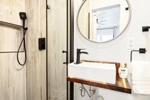 a bathroom with a sink and a mirror at Chic 3br Haven Fully Furnished & Private Carpot in Oklahoma City