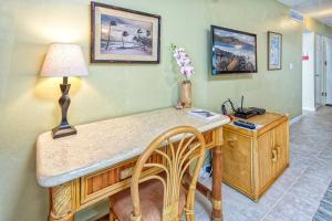 an office with a desk with a lamp and a chair at Beautiful Oceanfront Condo! - Hale Kona Kai 303 in Kailua-Kona +10 photos