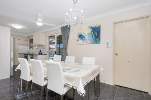 a dining room with a white table and white chairs at Vibrant, Lovely 3BR Family Home in North Ward