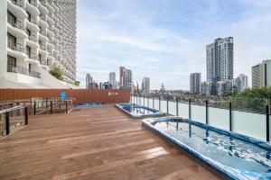 an outdoor swimming pool on the roof of a building at Gorgeous Private Suite with Balcony in Gold Coast
