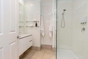 a white bathroom with a shower and a sink at Kasih in McCrae +18 photos