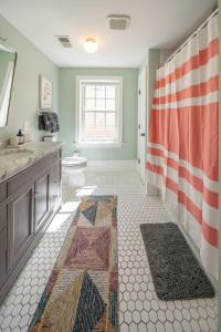 a bathroom with a sink and a toilet and a shower at The Walton House - historic 3bd 2 5ba with parking in Kennett Square