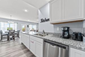 a kitchen with white cabinets and a counter top at Endless Summer condo in Branson West