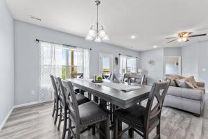 a dining room with a table and chairs and a couch at Endless Summer condo in Branson West