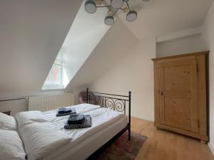 a bedroom with a bed with white sheets and a window at Haardter Mandelring in Neustadt an der Weinstraße