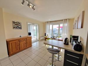 a kitchen with a table and a counter top at Appartement avec Piscine, Tennis & Balcon, Centre-ville Chatelaillon-Plage, 6 Pers, 2 Ch - FR-1-706-17 in Châtelaillon-Plage