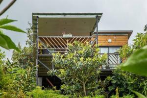 a tree house with a balcony and trees at Le Panorama in Cilaos