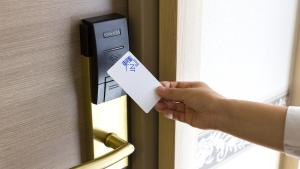 a person unlocking a door with a piece of paper at Toyoko Inn Osaka Namba in Osaka