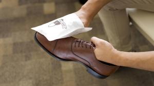 a person is holding their foot in a shoe at Toyoko Inn Osaka Namba in Osaka