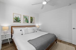 a white bedroom with a bed and a ceiling fan at Duneside Bliss - Steps to the Ocean & Mins to DT in Saint Augustine