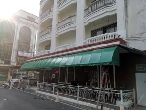 a building with a green awning in front of it at Cat Home Hat Yai in Hat Yai