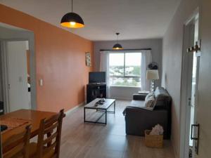 a living room with a couch and a table at Depto Rawson Home in Rawson