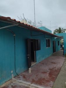 a blue building with a parking lot in front of it at casa en playa santa clara yucatan in Santa Clara