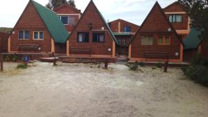 a row of wooden homes on a beach at El Cristal in Puerto Pirámides